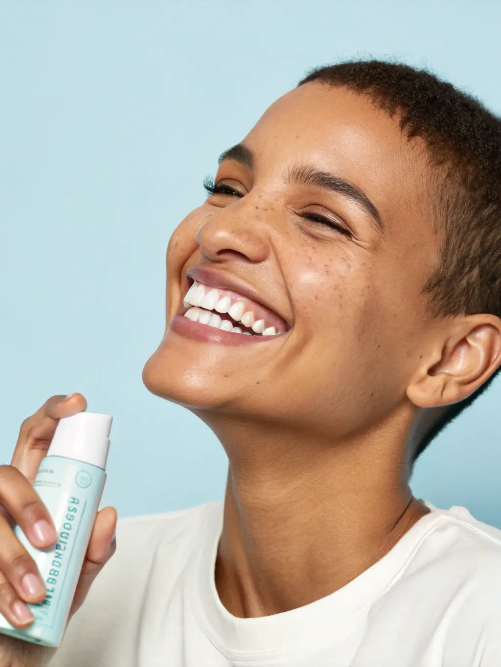 Close-up of a person smiling confidently, showcasing visibly whiter teeth after using Luminous Teeth Whitener. The background is blurred to keep the focus on the smile.